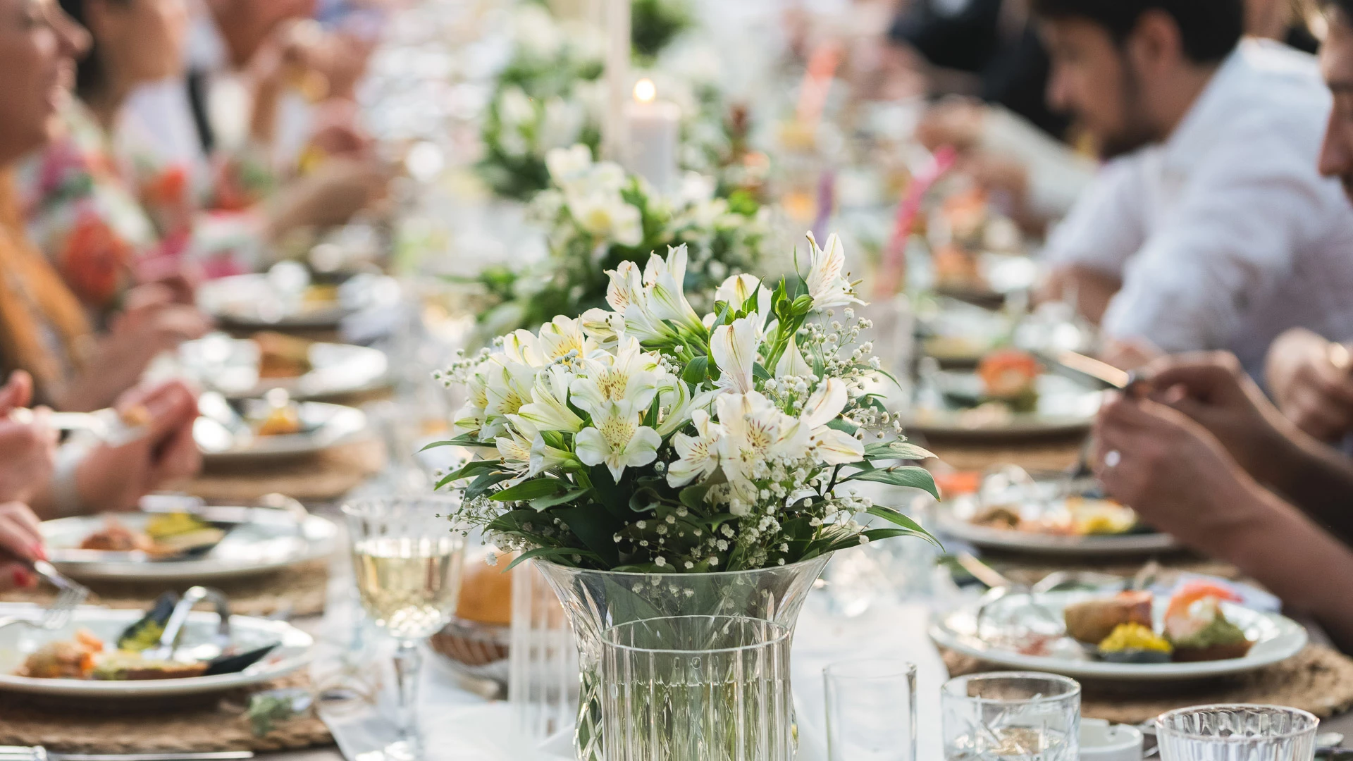 Elegant wedding tablescape with white flowers and fine dining setup